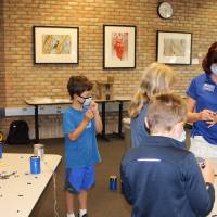 Students work on their bee house projects